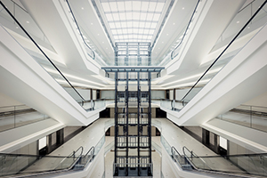 Fachplaner für Aufzüge - LiftPLAN360: Modernes Treppenhaus eines Gebäudes mit mehreren Treppen und Aufzügen.